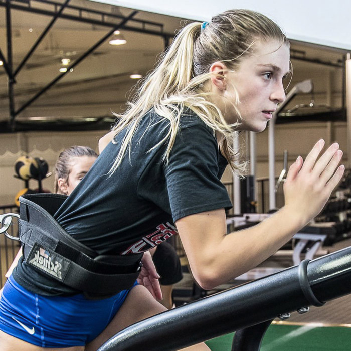 woman running with resistance band around her waist